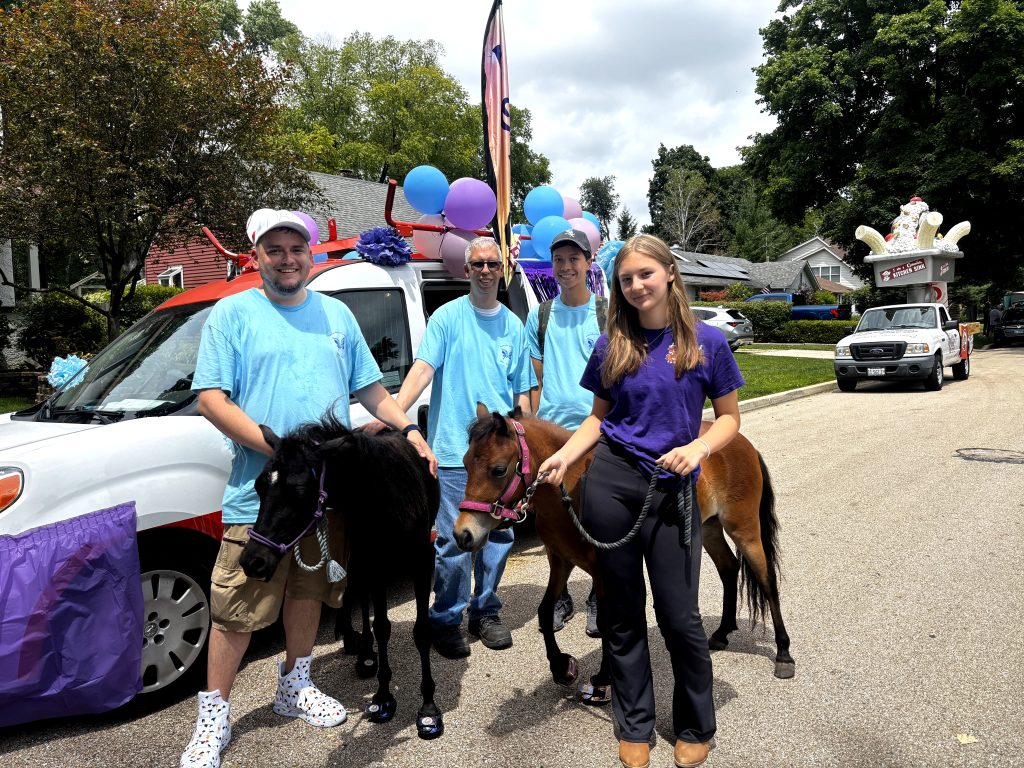 Oreo, Cocoa and the team at an outdoor community event